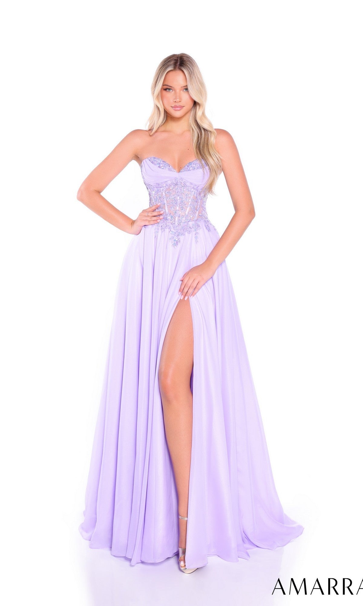 A woman stands against a white background wearing the Amarra 89315 long prom dress, featuring a strapless hot-stone embellished bodice and a flowing chiffon A-line skirt with a high slit.